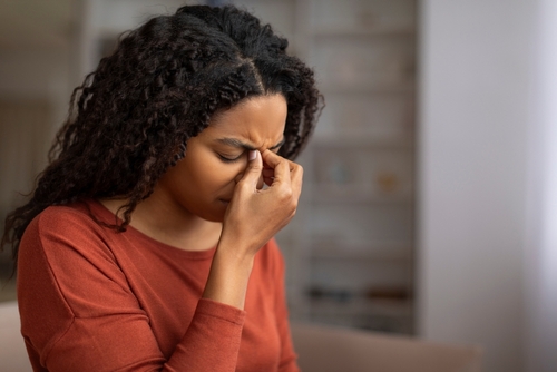 Lady holding her sinus.